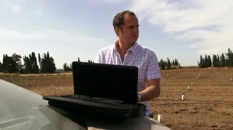 Guy working on the field with laptop. Typing. Stock Footage 20512770