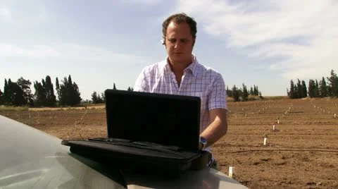 Guy working on the field with laptop. Typing. Stock Footage 20512827