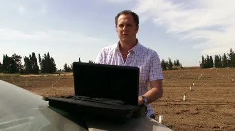Guy working on the field with laptop. Typing. Stock Footage 20512828