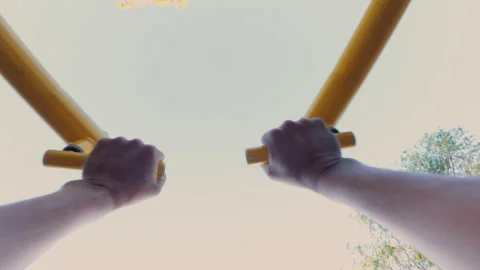 The guy is working out on a simulator on the playground. From the first person. Stock Footage 316844385