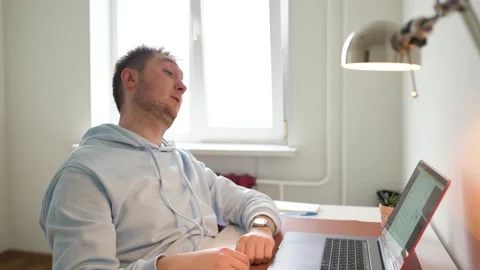 The guy works at the computer all day, tired, yawns, looks at the clock Stock Footage 154646727