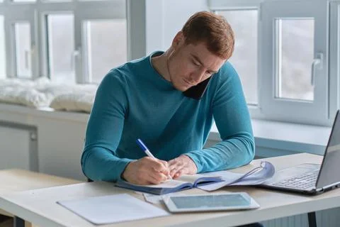 Guy works from home. man using laptop, typing on keyboard, writing email or Stock Photos