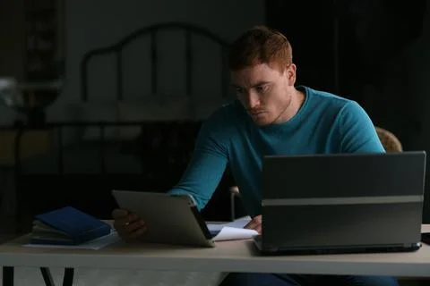 Guy works from home. man using laptop, typing on keyboard, writing email or Stock Photos