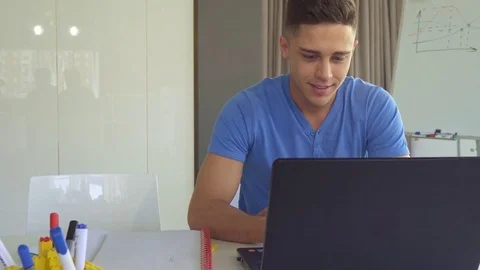 Guy works on laptop at the office Stock Footage 76402674