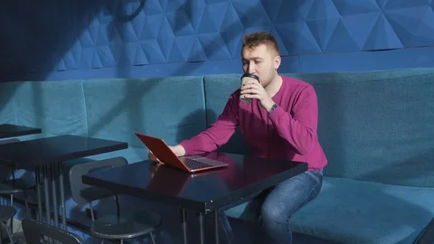 Guy works laptop remotely gets angry punches table, grabs his hands on his head Stock Footage 127211484