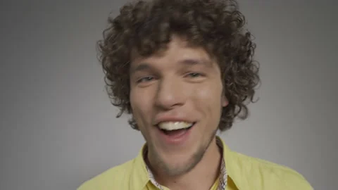 Guy wriggs and laughs at the camera in the studio on an isolated background. He Stock Footage 139469791