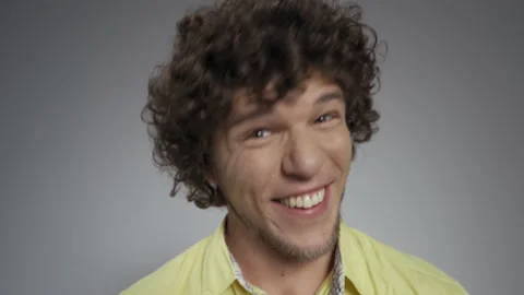 Guy wriggs and laughs at the camera in the studio on an isolated background. He Stock Footage 140782459