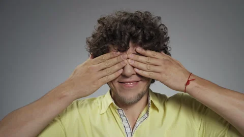 Guy wriggs and laughs at the camera in the studio on an isolated background. He Stock Footage 140782566
