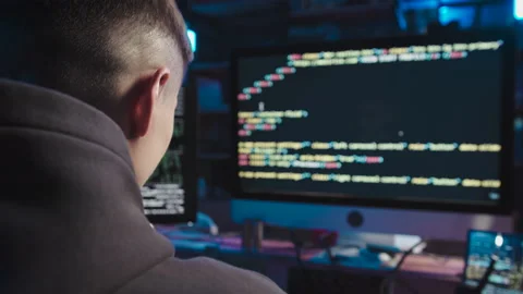 The guy writes the code for the program Video stock 185484454