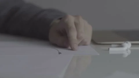 The guy writes, draws. The guy is sitting at the table by the laptop Stock Footage 130220110