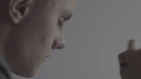 The guy writes, draws. The guy is sitting at the table by the laptop Stock Footage 130220244