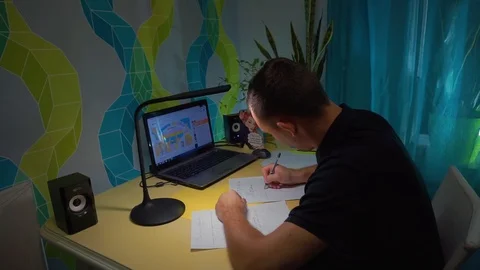 The guy writes on a piece of paper at the desk with a beautiful handwriting Stock Footage 121855166