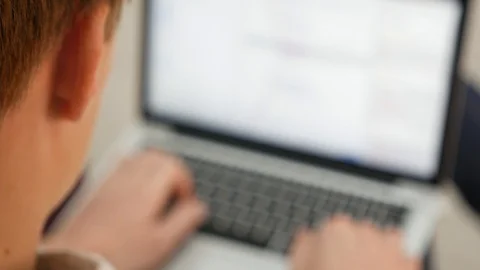 Guy writes the software on the laptop Stock Footage 89090129