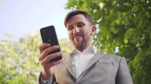 The guy writes a text message with both hands.  Stock Footage 187021734