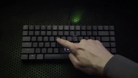 The guy writes the word "internet" on a glowing keyboard with one hand Stock Footage 242395577
