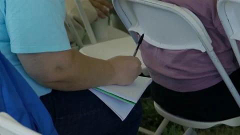 Guy writing on notepad Stock Footage 197847920