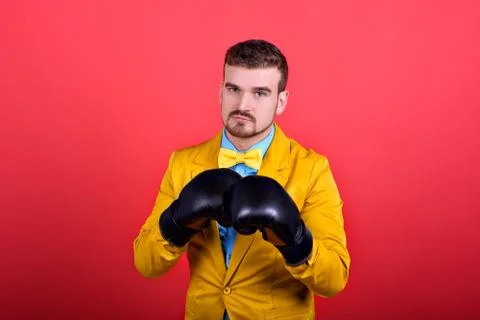 Guy in yellow jacket and boxing gloves Stock Photos