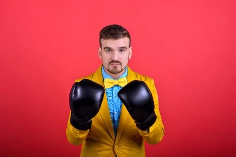 Guy in yellow jacket and boxing gloves Stock Photos