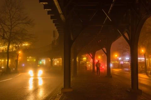The guy with a yellow jacket under a elevated railway Stock Photos