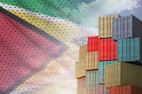 Guyana flag and big stack of shipping cargo containers in docks with sky Stock Photos