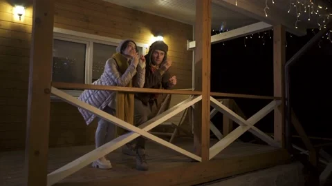 The guys are chatting and dancing. Lovers in the mountains in a wooden house Video stock 167651245