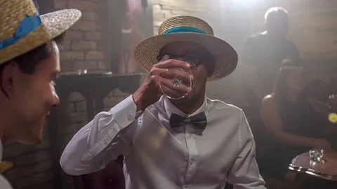 Guys are discussing something and also drinking and smoking in between Stock Footage 112190810