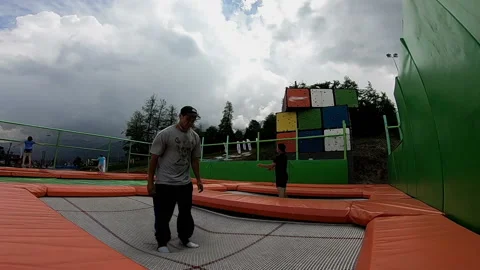 Guys are jumping on the trampoline Video stock 102323895