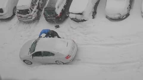 The guys are pushing a car stuck in the snow Stock Footage