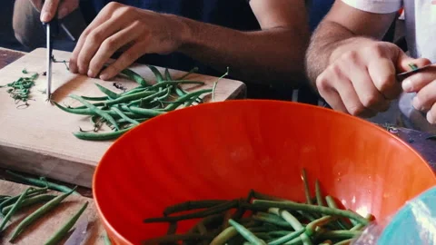 Guys cutting green beans for cooking Stock Footage 218591998