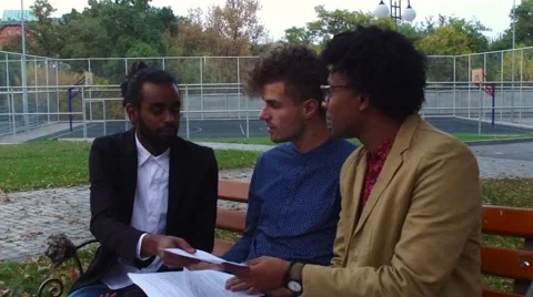 Guys discuss papers on the street Stock Footage 68593803