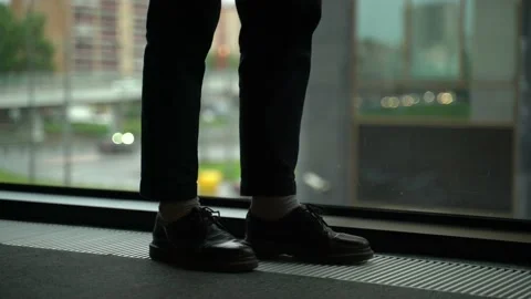 Guy's feet by the window Stock Footage 131511337