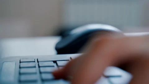 Guy's hands are typing on the keyboard. Camera movement along the keyboard Stock Footage 136309575