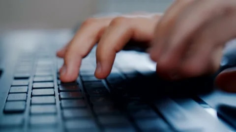 Guy's hands are typing on the keyboard. Camera movement along the keyboard Stock Footage 160922278