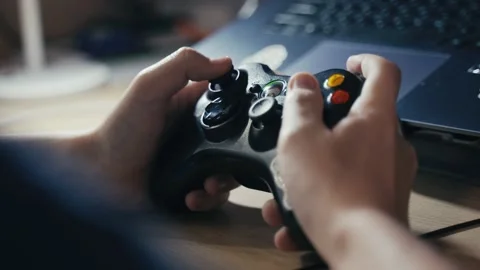 The guy's hands close-up on the game joystick. The young man plays computer Stock Footage 166043781