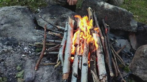 Guy's hands light a fire with matches in close-up. Stock Footage 170627045