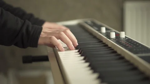 Guy's hands playing the keyboard Stock Footage 111384670