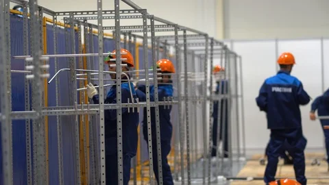 Guys install metal structure from channels bars. Working environment at factory Stock Footage 126357843