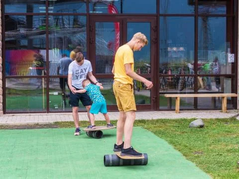 The guys learn to keep their balance on the board. Rosa Khutor. Height 1100 m Stock Photos