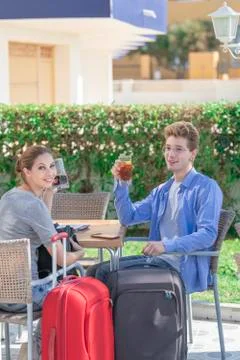 Guys looking at the camera while drinking soda in a restaurant with their sui Stock Photos