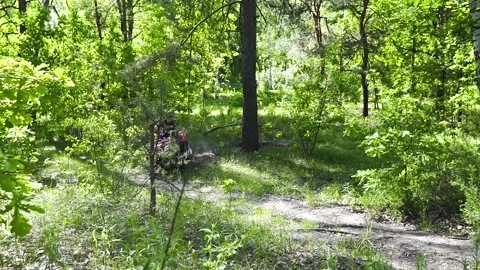 The guys, the men on the ATV, make a sharp turn. Stock Footage 139884491