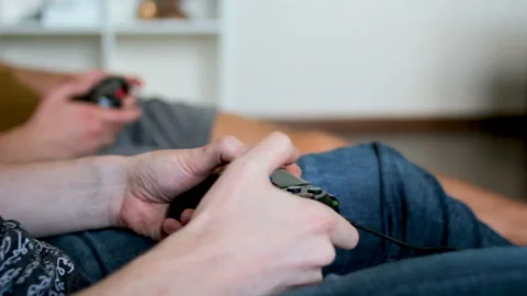 Guys play a video game using joysticks Stock Footage 91358219