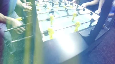 Guys playing Foosball Table soccer at a sports bar Stock Footage 45430347