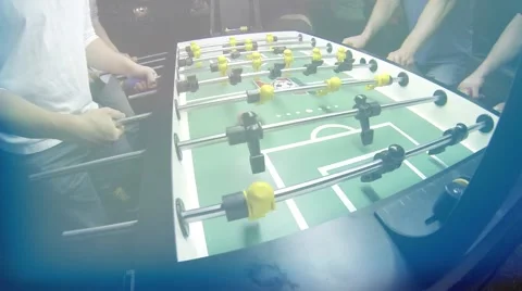 Guys playing Foosball Table soccer at a sports bar Stock Footage 45430371