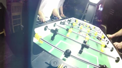 Guys playing Foosball Table soccer at a sports bar Stock Footage 45430409