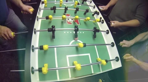 Guys playing Foosball Table soccer at a sports bar Stock Footage 45430807