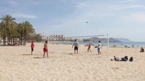 Guys playing volleyball on the beach Stock Footage 256909902