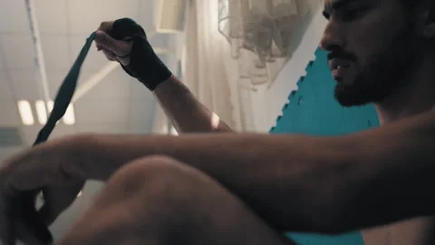 Guys puts on wrist wrap Stock Footage 275431512