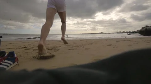 Guys running into the sea - Slowmotion Stock Footage 67007421