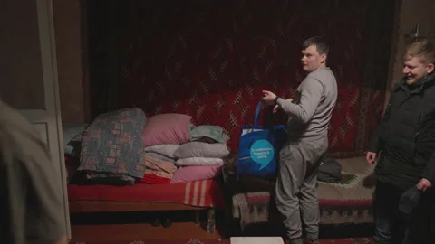 Guys settle down for the night in a house Stock Footage 231710126