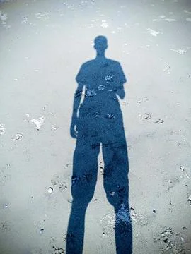 A guy's shadow on the sand Photos